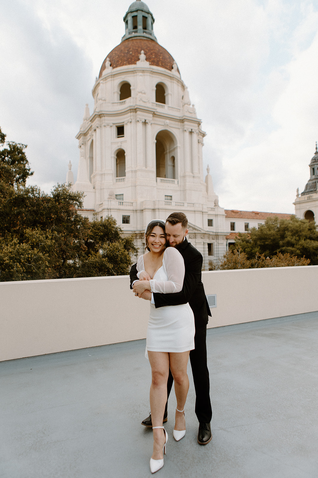Bride and groom standing on bridge at Pasadena City Hall for their elopement