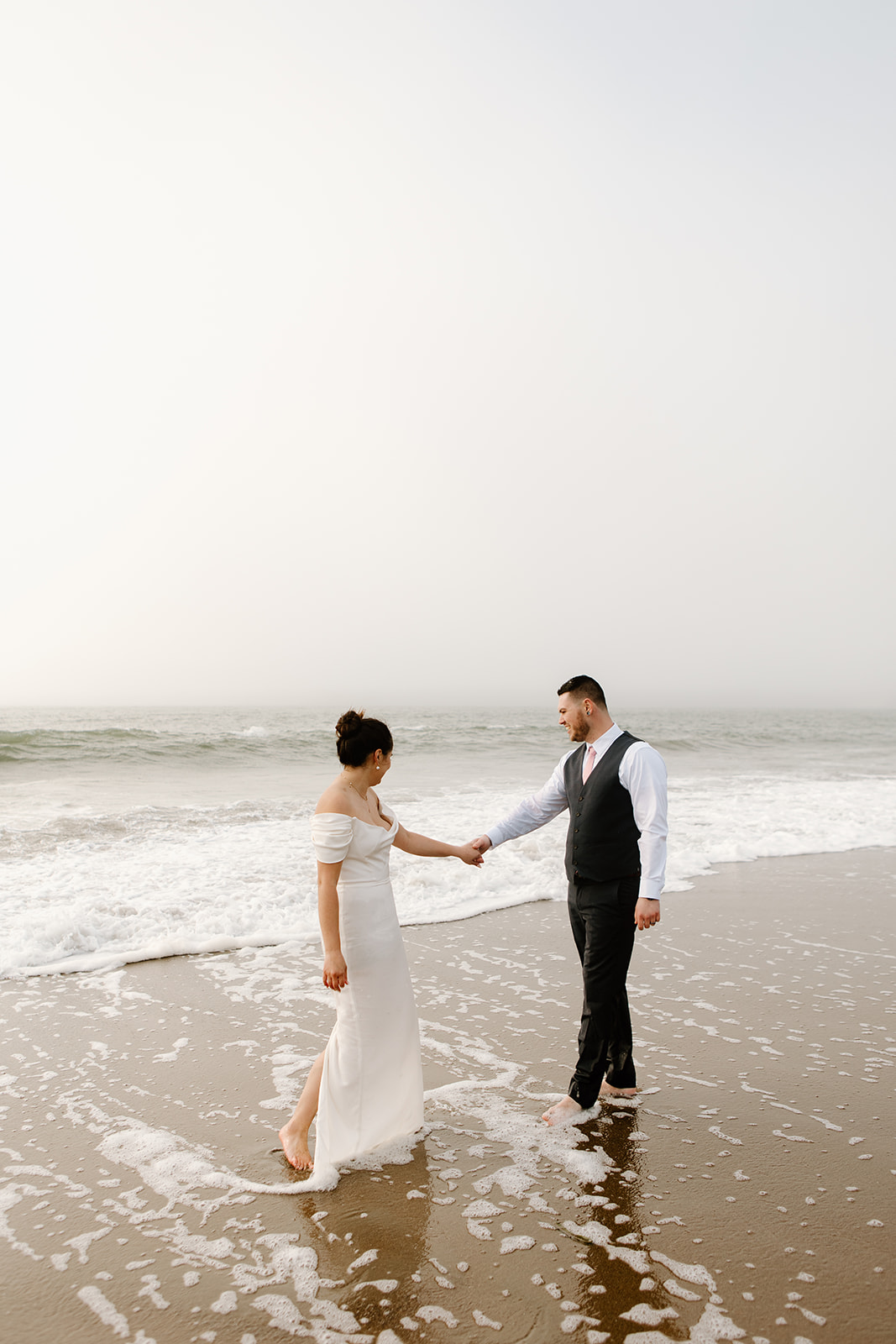 Bride and groom celebrate their SF City Hall wedding with an after party at the beach including pizza and champagne