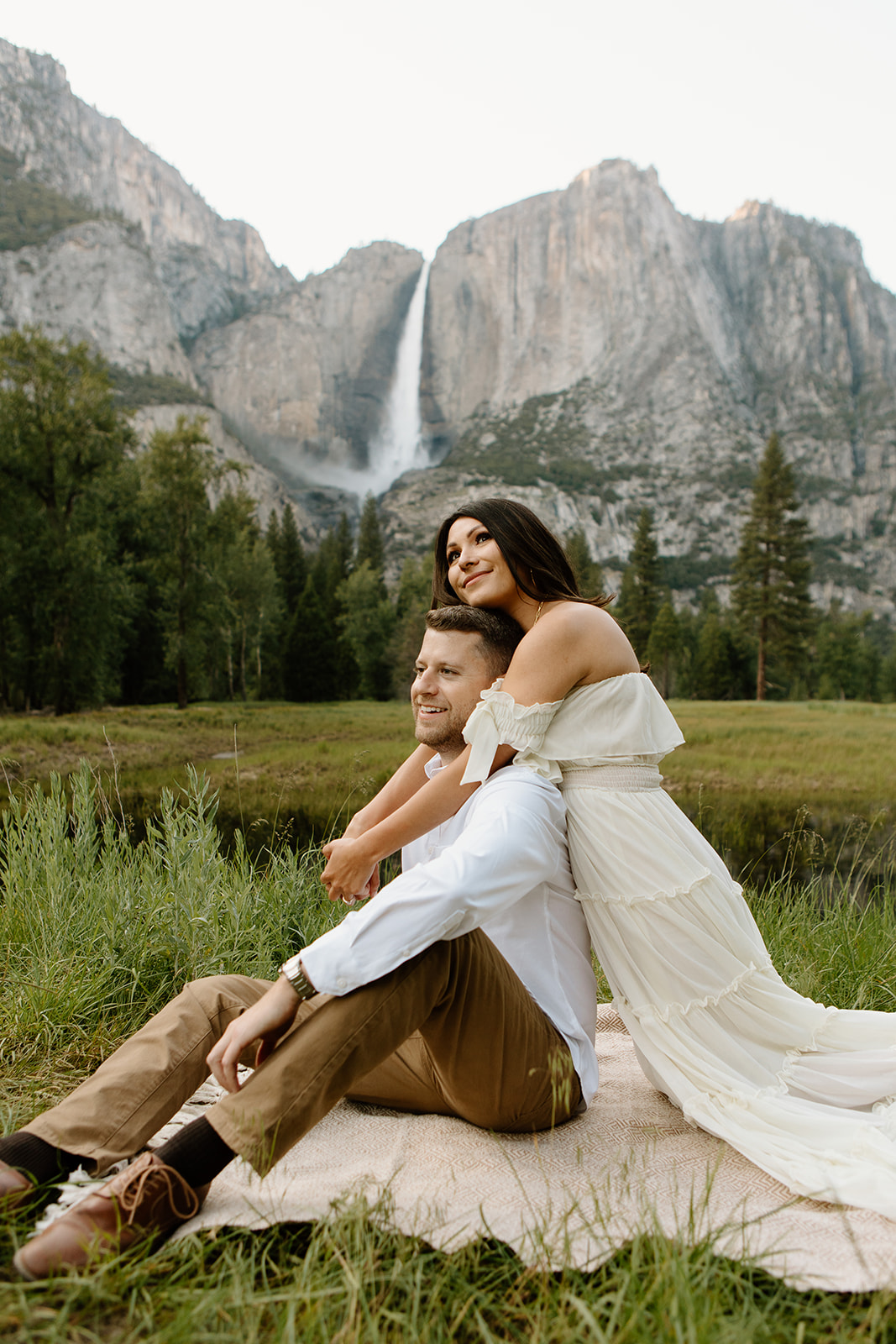 Jessica and Mike taking engagement photos in Yosemite valley with Yosemite Valley falls as the backdrop