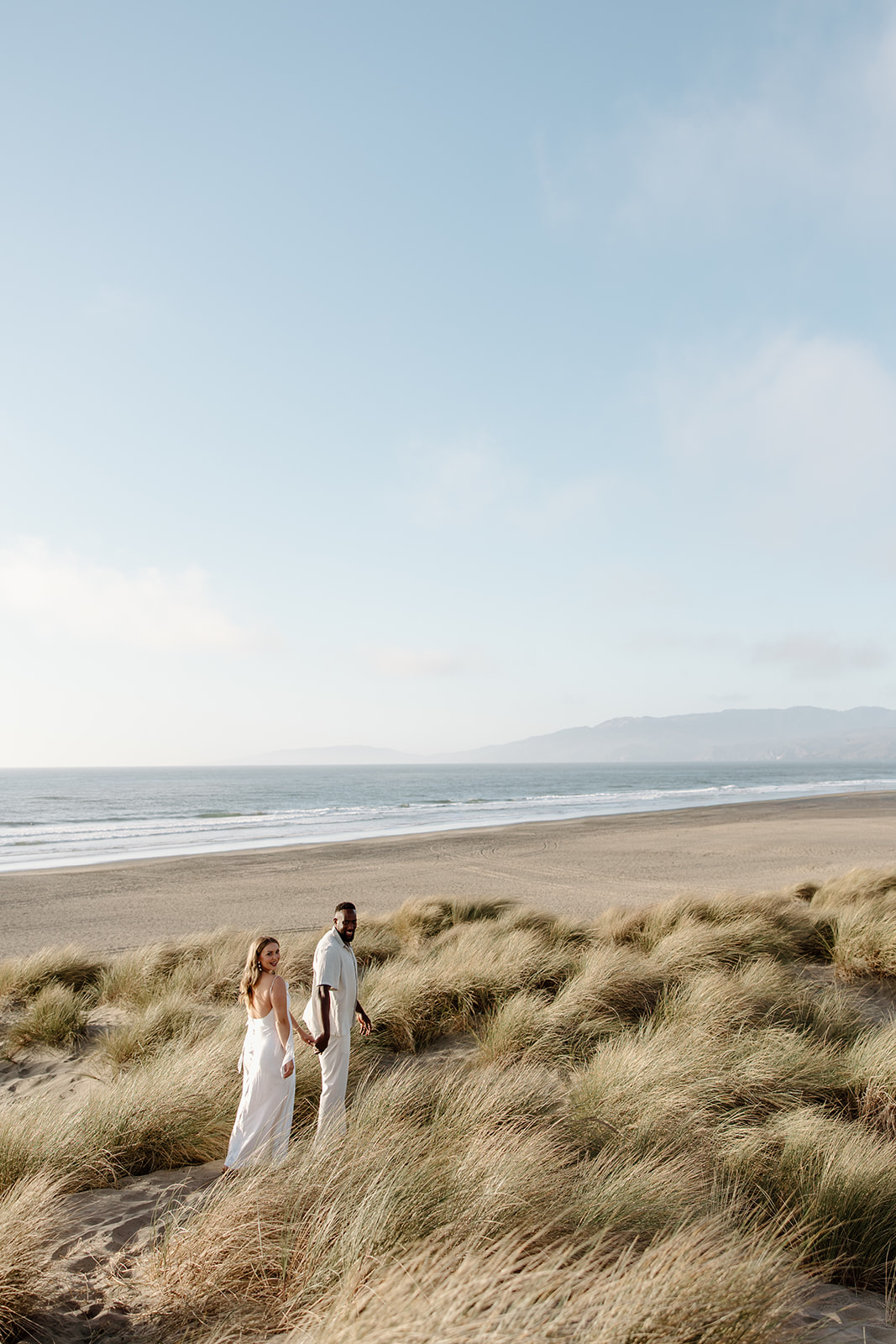 engagement photos at ocean beach sand dunes in san francisco